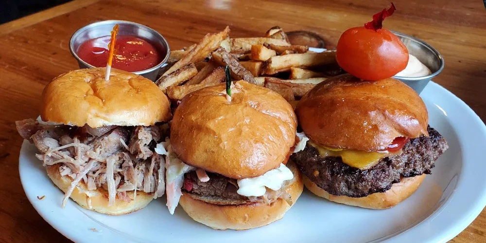 Burgers and French fries on a plate at the Beer Parlour and Ghost Kitchen | Bala Bay Inn, Muskoka and Bala's historic hotel, Established in 1910