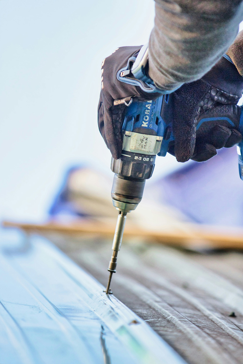 Person drilling a hole with a drill close up | Bala Bay Inn