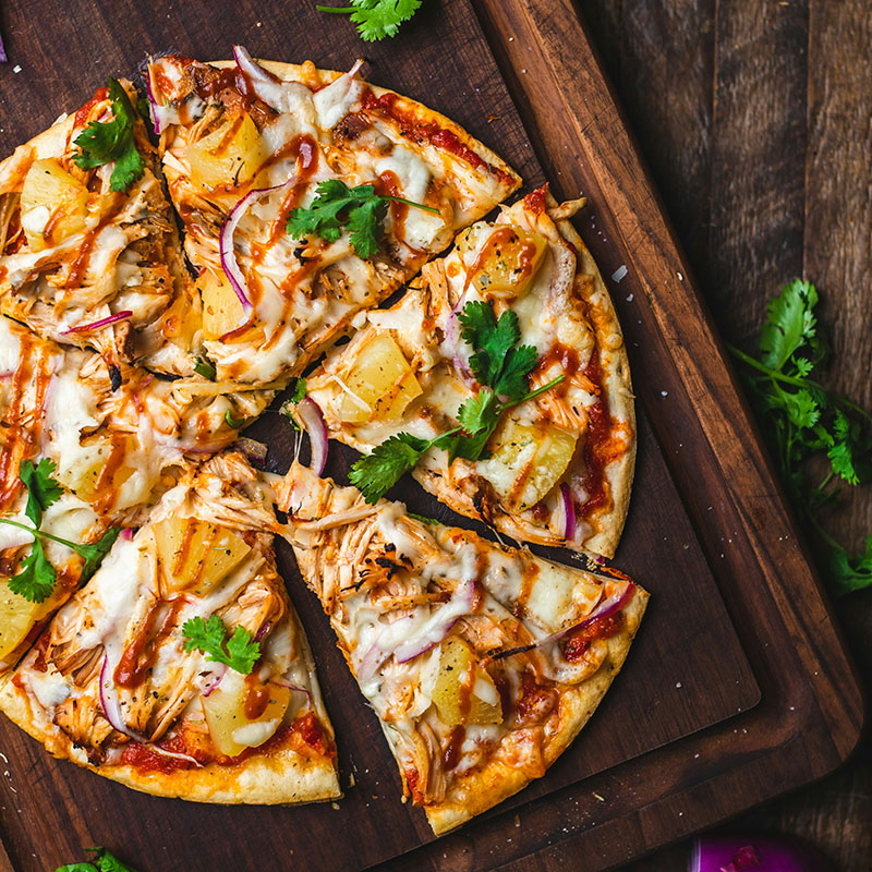 Pizza sitting on a wooden board | Bala Bay Inn Food