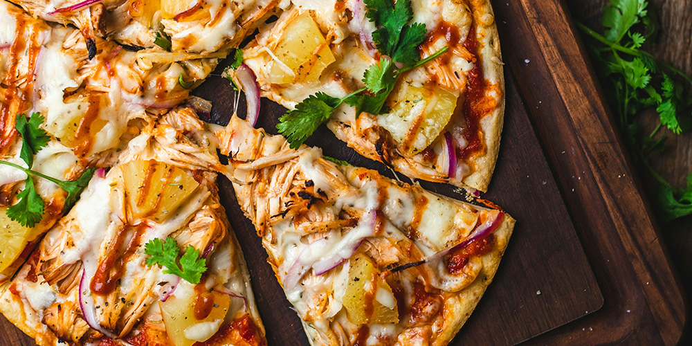 Pizza with a slice taken out at the Clear Lake Distilling Company | Bala Bay Inn, Muskoka and Bala's historic hotel, Established in 1910