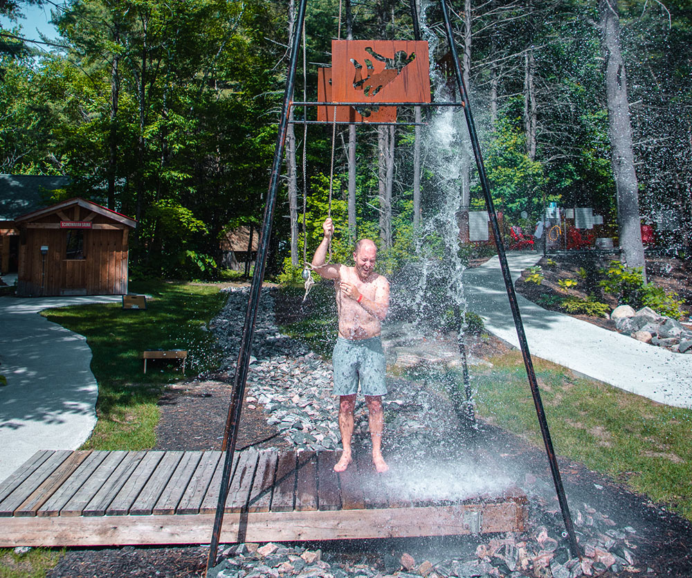 Man dumping a full water bucket on his head at the Muskoka BeerSpa