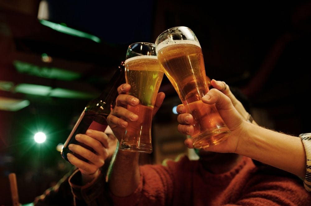 Friends clinking beer glasses together