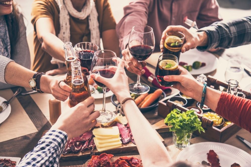 Closeup of group having dinner and drinks and a restaurant