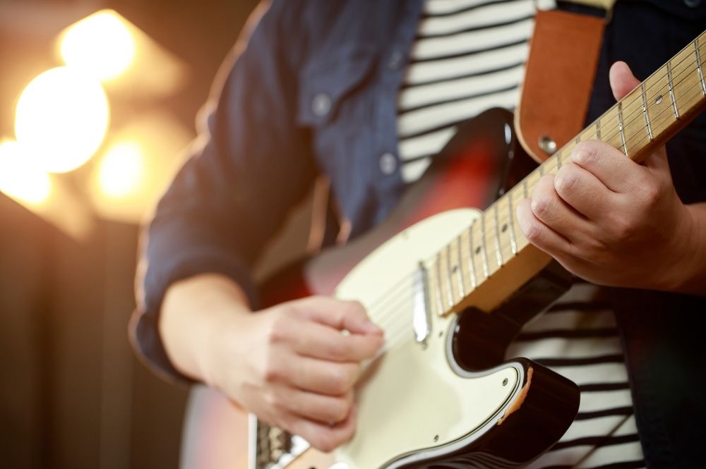 Closeup of man playing a guitar